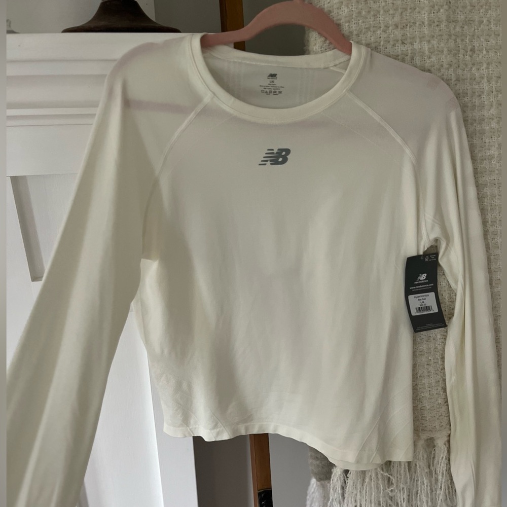 New Balance Women’s top. NWT. Sea salt color. Retail $50. Size large. 100%nylon
